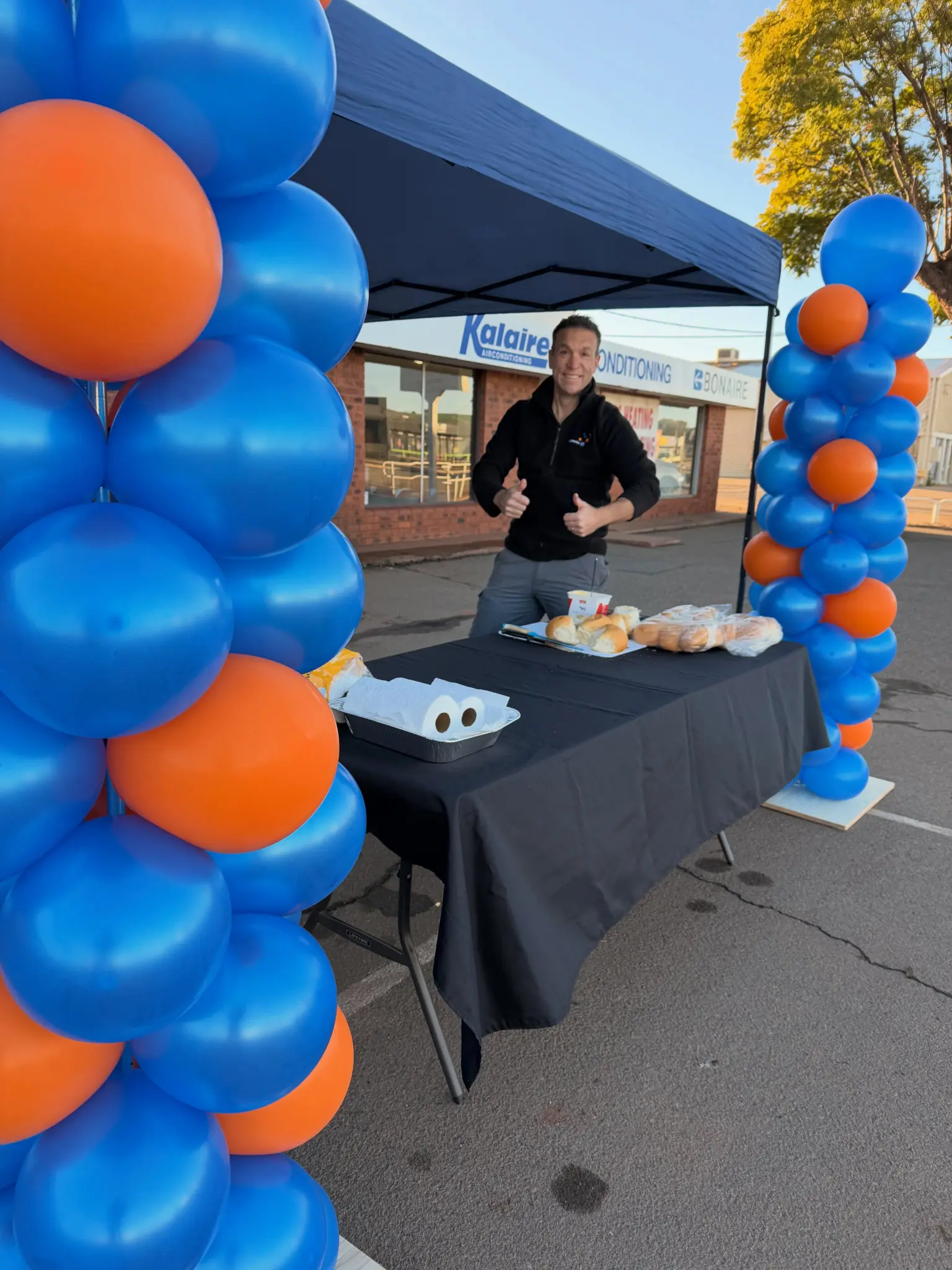 Kalgoorlie IT team member welcoming visitors at the company’s 15-year celebration outside the store.