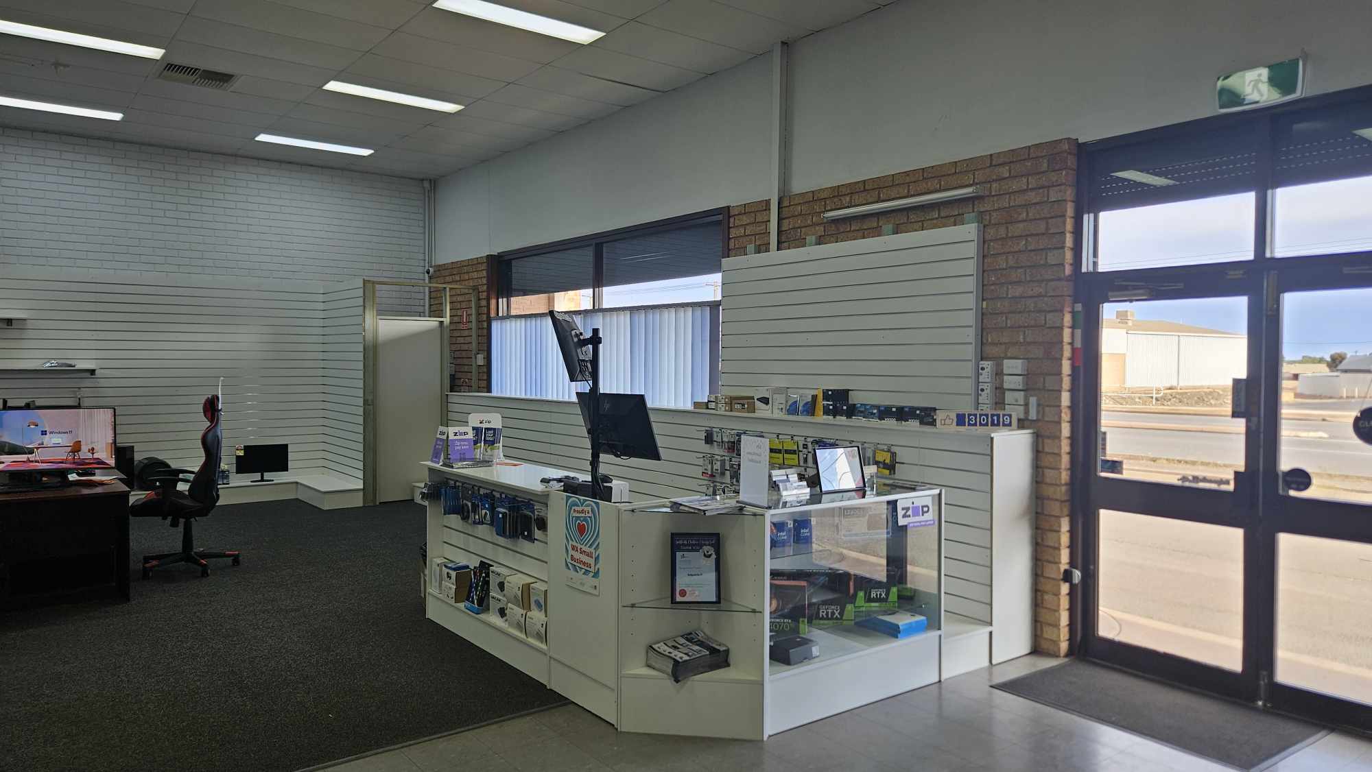 Interior of Kalgoorlie IT's retail store, showing the service counter, technology displays and customer entrance.